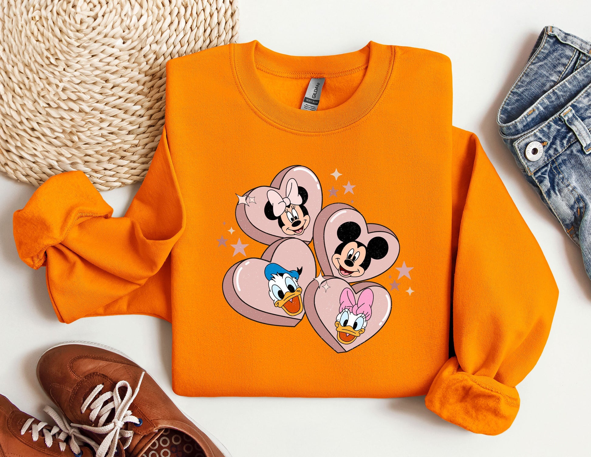 a pair of sneakers and a sweatshirt with mickey mouse on it