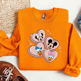 a pair of sneakers and a sweatshirt with mickey mouse on it