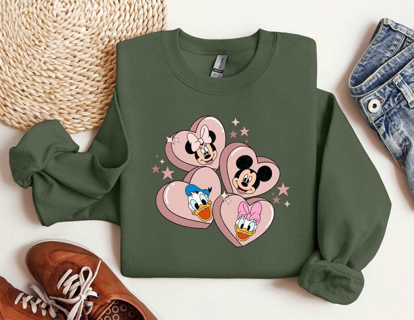 a green sweatshirt with mickey and minnie mouses on it