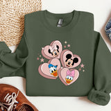 a green sweatshirt with mickey and minnie mouses on it