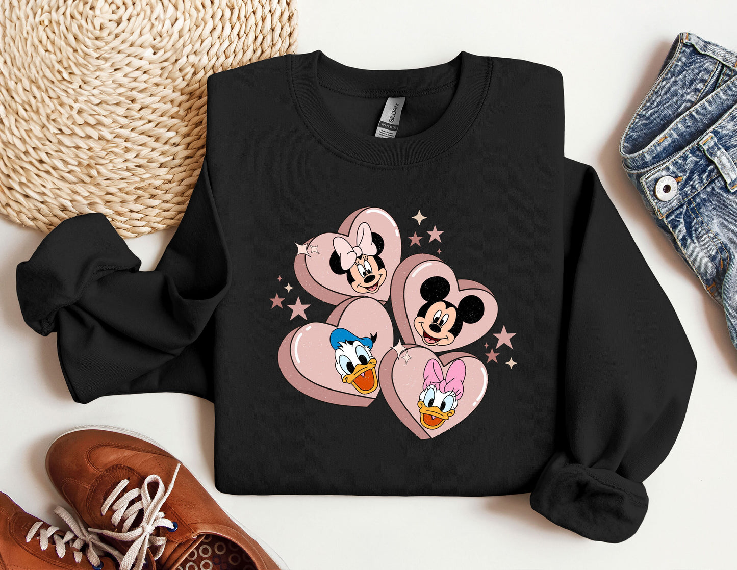 a black sweatshirt with mickey and minnie mouses on it