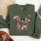 a green sweatshirt with a mickey mouse design on it
