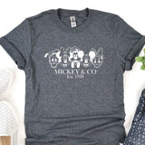 a mickey and mickey mouse t - shirt next to a pair of shoes