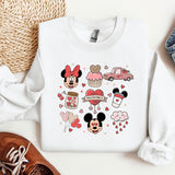 a mickey mouse shirt and some shoes on a table