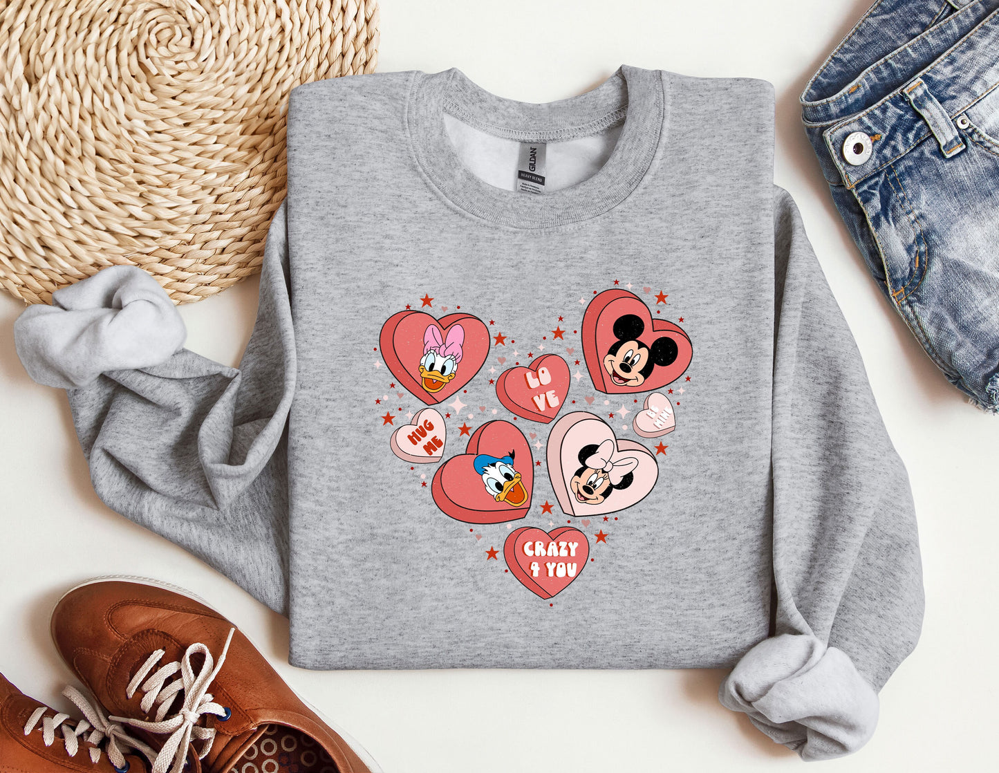 a gray sweatshirt with mickey and minnie mouses on it