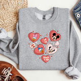a gray sweatshirt with mickey and minnie mouses on it