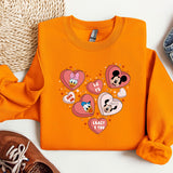 a pair of sneakers and a sweatshirt with mickey mouse on it