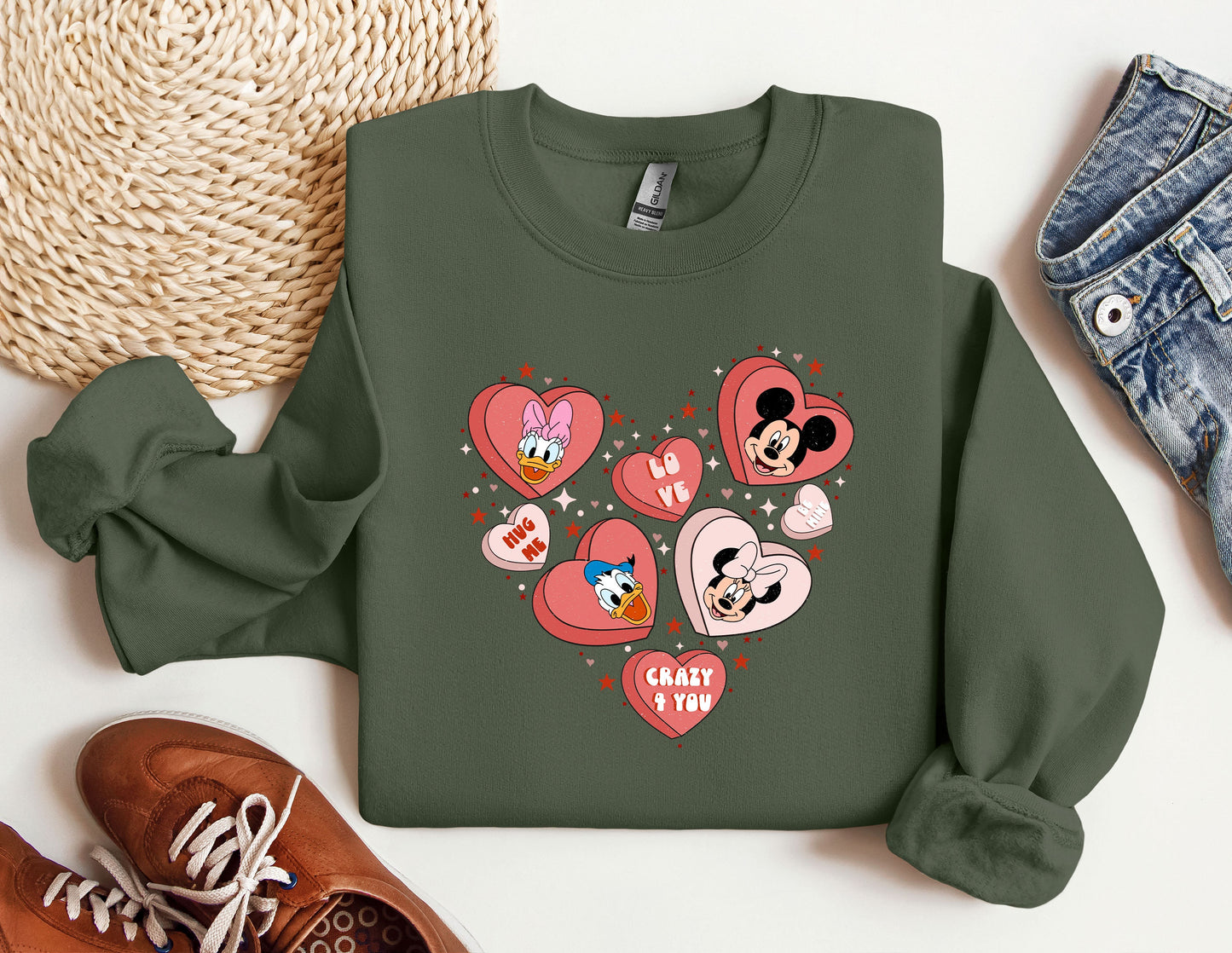 a green sweatshirt with hearts and mickey mouses on it