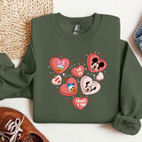 a green sweatshirt with hearts and mickey mouses on it