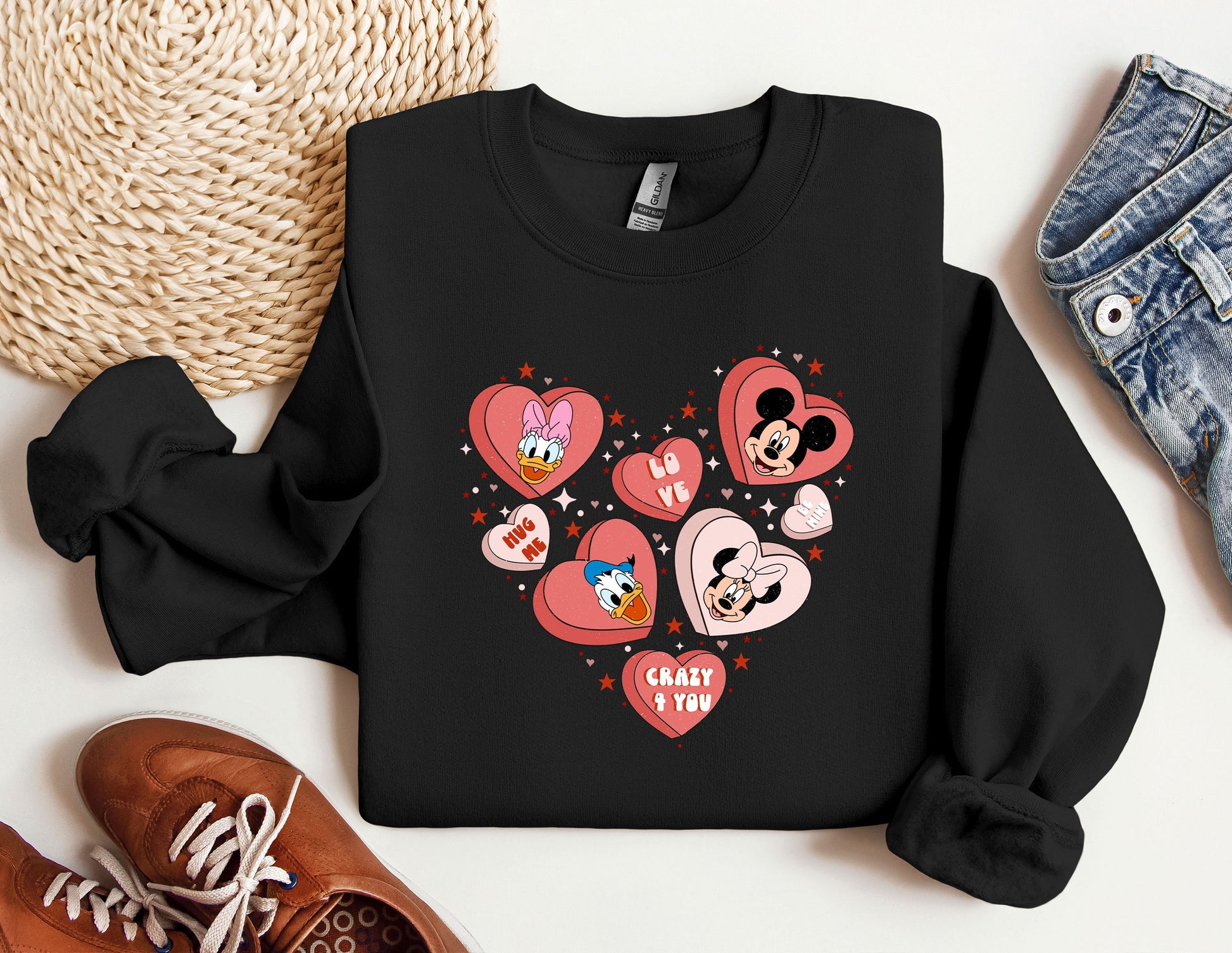 a black sweatshirt with hearts and mickey mouses on it