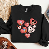 a black sweatshirt with hearts and mickey mouses on it