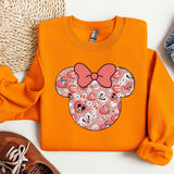 an orange shirt with a pink bow on it