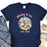 a mickey and mickey mouse t - shirt next to a pair of jeans
