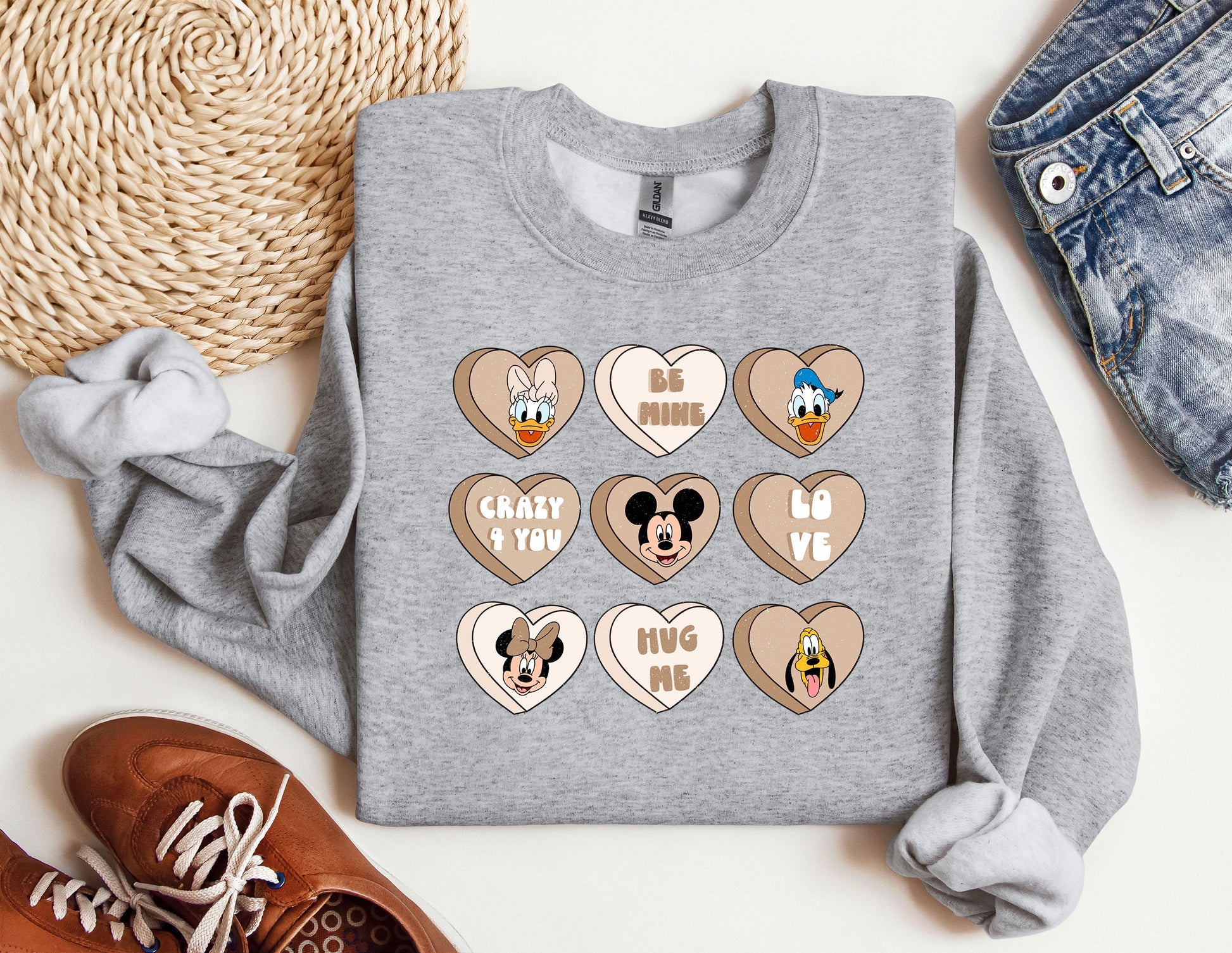 a gray sweatshirt with mickey mouse and mickey mouse hearts