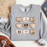 a gray sweatshirt with mickey mouse and mickey mouse hearts