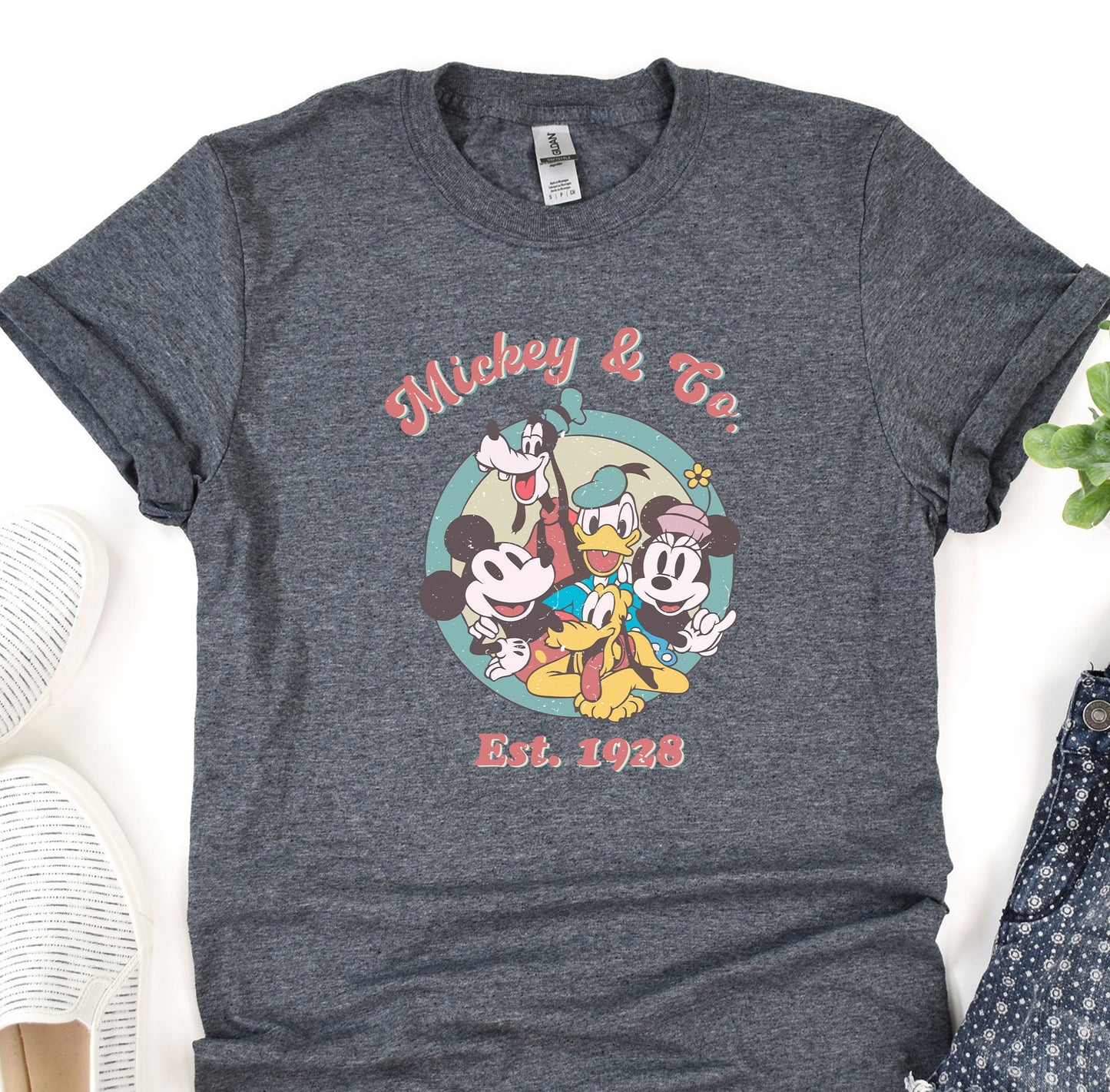 a mickey mouse t - shirt sitting on top of a table