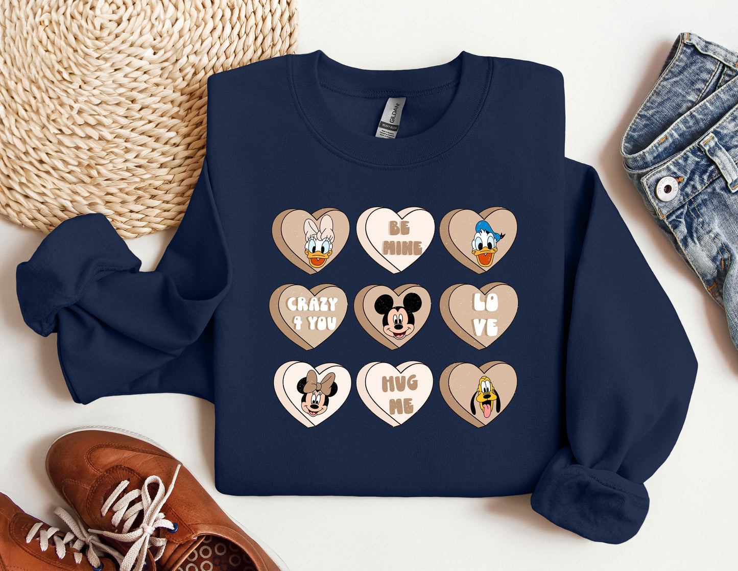 a blue sweater with mickey mouse hearts on it