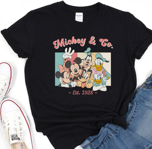 a mickey and mickey mouse t - shirt next to a pair of jeans