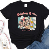a mickey and mickey mouse t - shirt next to a pair of jeans