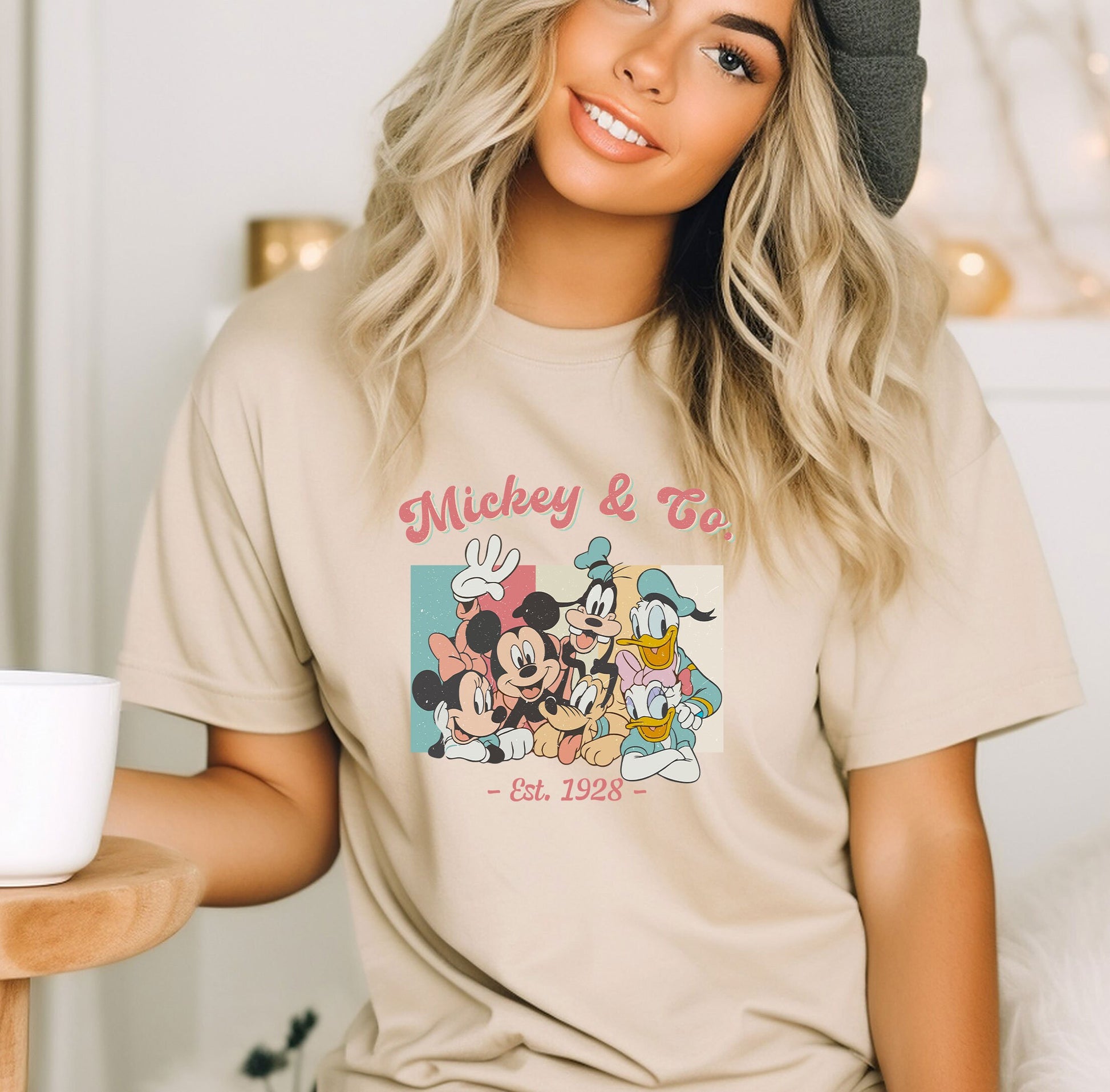 a woman wearing a mickey and minnie mouse t - shirt