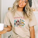 a woman wearing a mickey and minnie mouse t - shirt