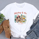 a mickey and mickey mouse t - shirt next to a pair of jeans