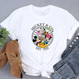 a mickey and mickey mouse t - shirt sitting on top of a table