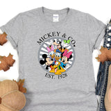 a mickey and mickey mouse shirt sitting on top of a table