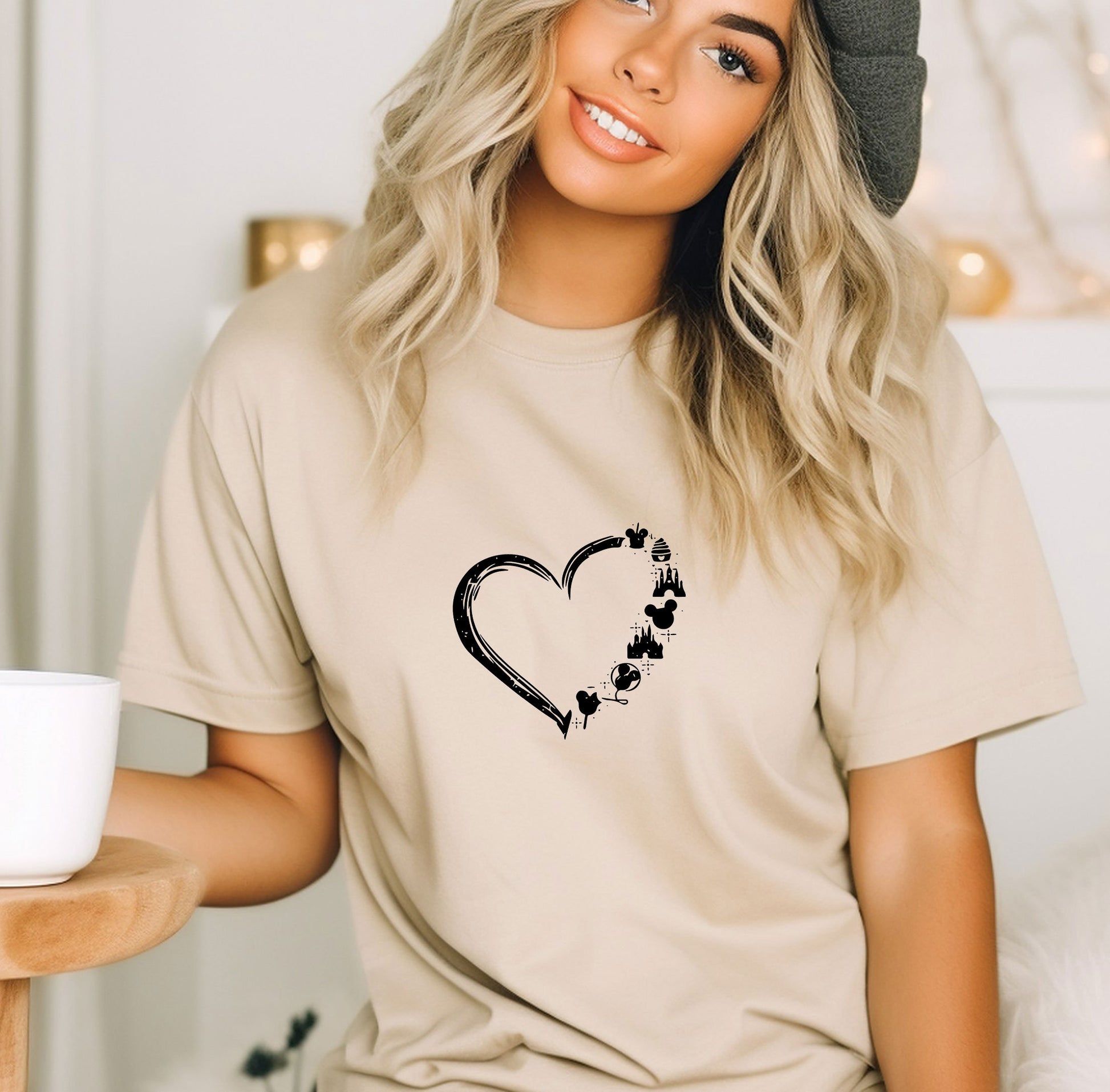 a woman wearing a t - shirt with a heart and paw prints