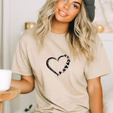 a woman wearing a t - shirt with a heart and paw prints