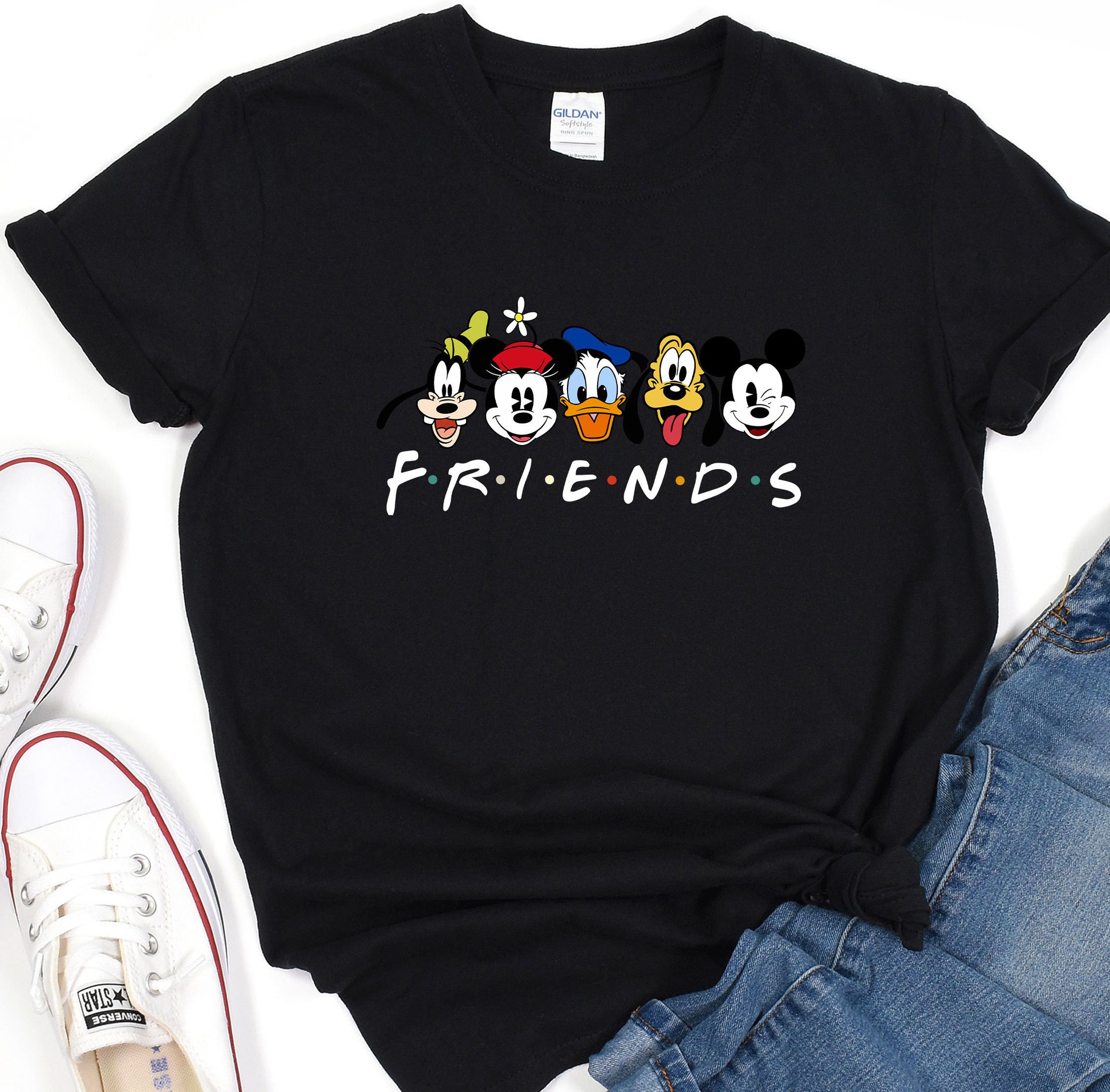 a black shirt with three cartoon characters on it