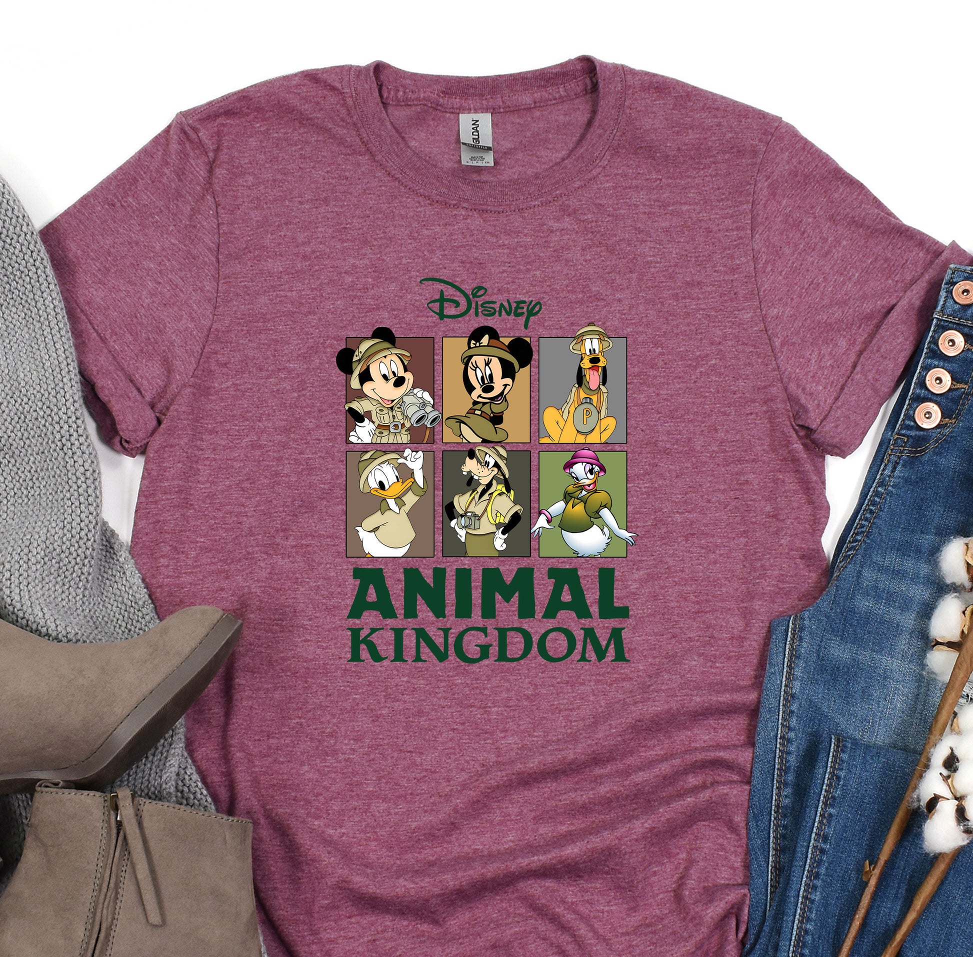 an animal kingdom t - shirt on a pile of clothes