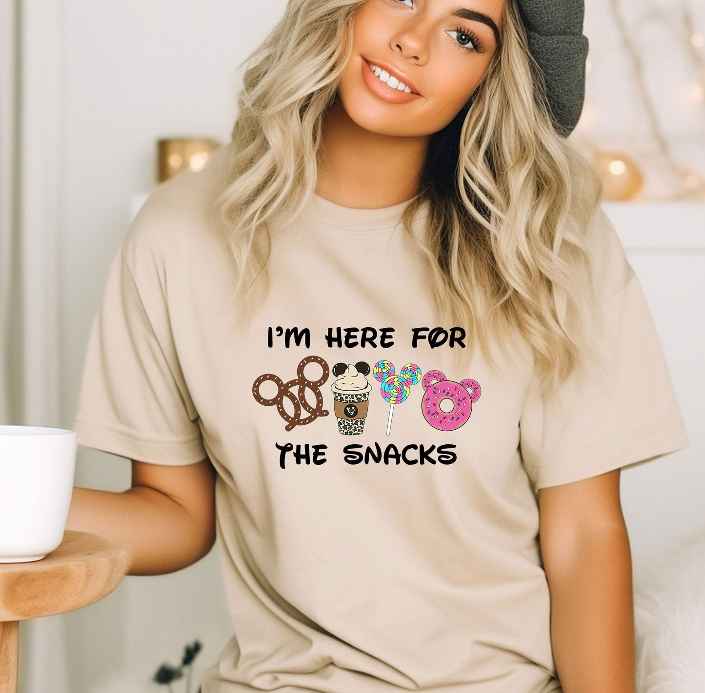 a woman wearing a t - shirt that says i&#39;m here for the snacks