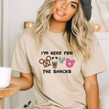 a woman wearing a t - shirt that says i'm here for the snacks