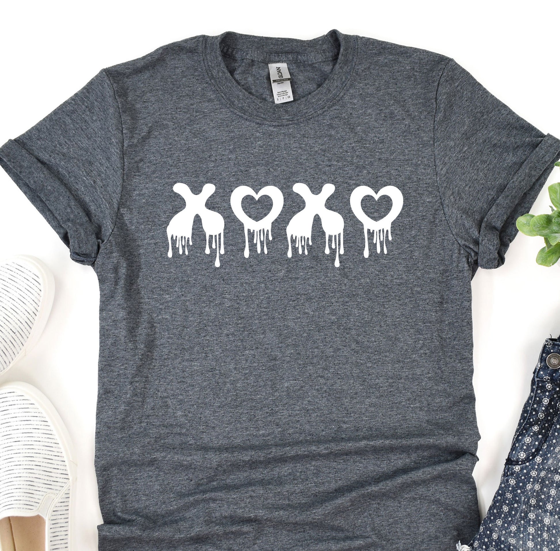 a t - shirt with the word love on it next to a pair of shoes