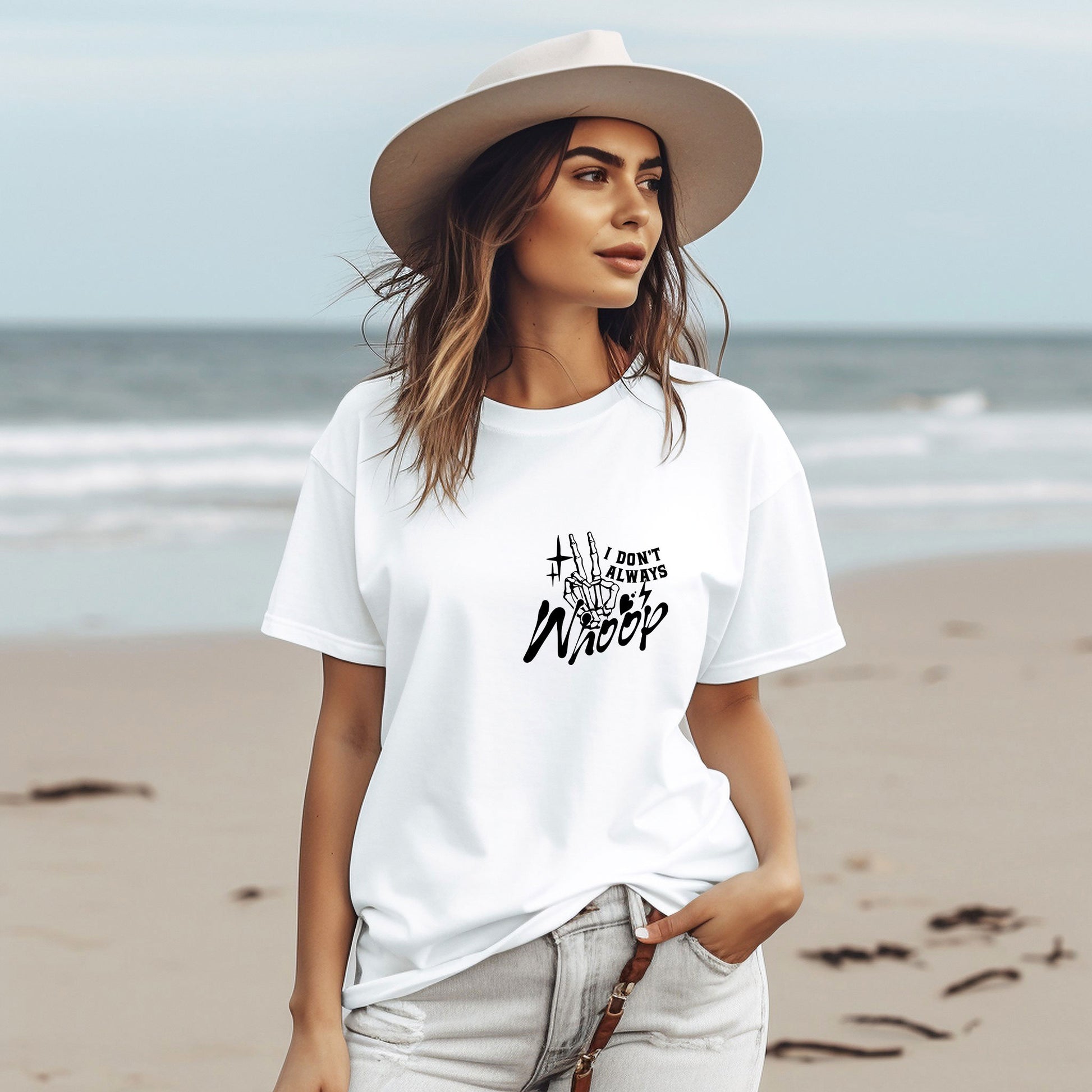 a woman wearing a white t - shirt and hat on the beach