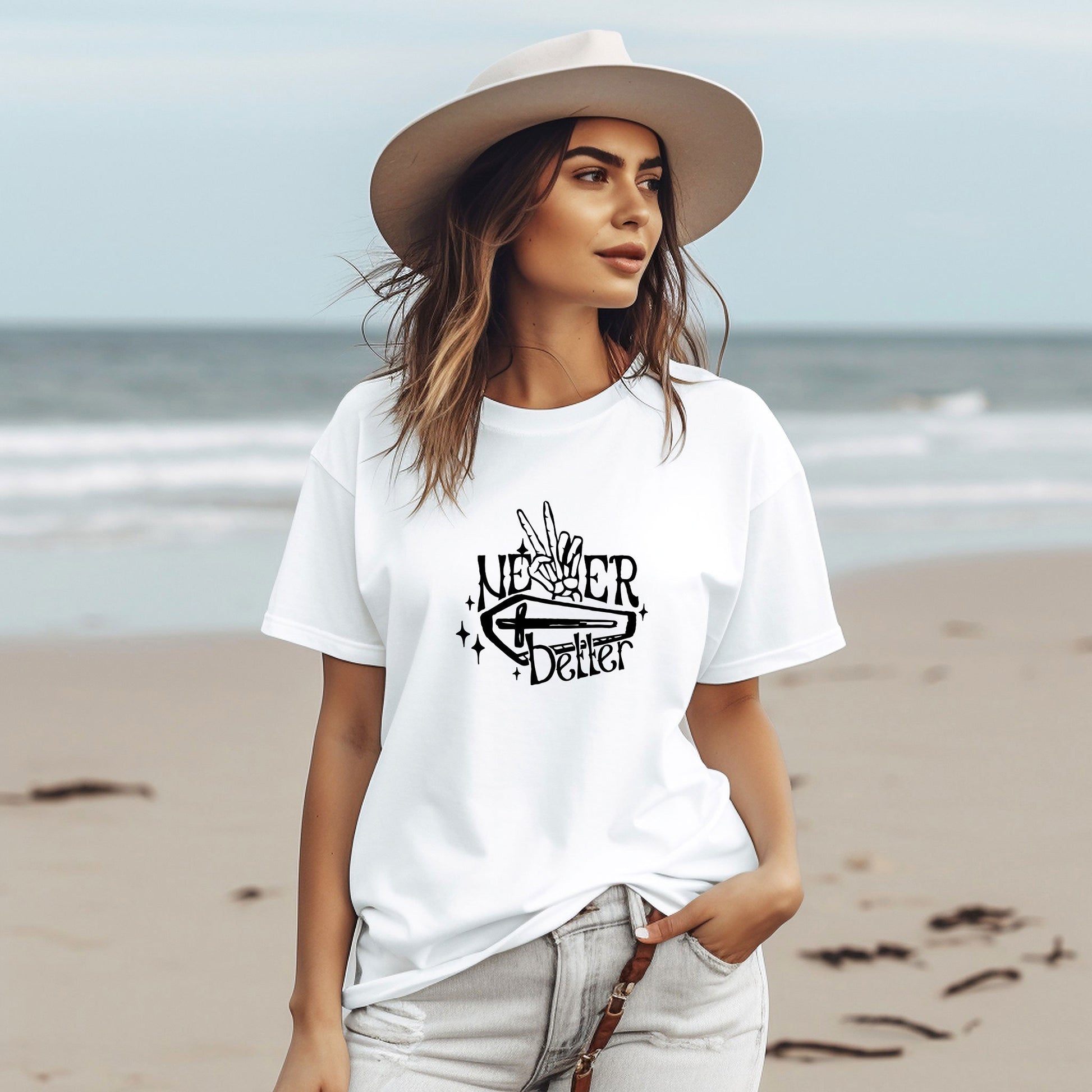 a woman wearing a white t - shirt and hat on the beach