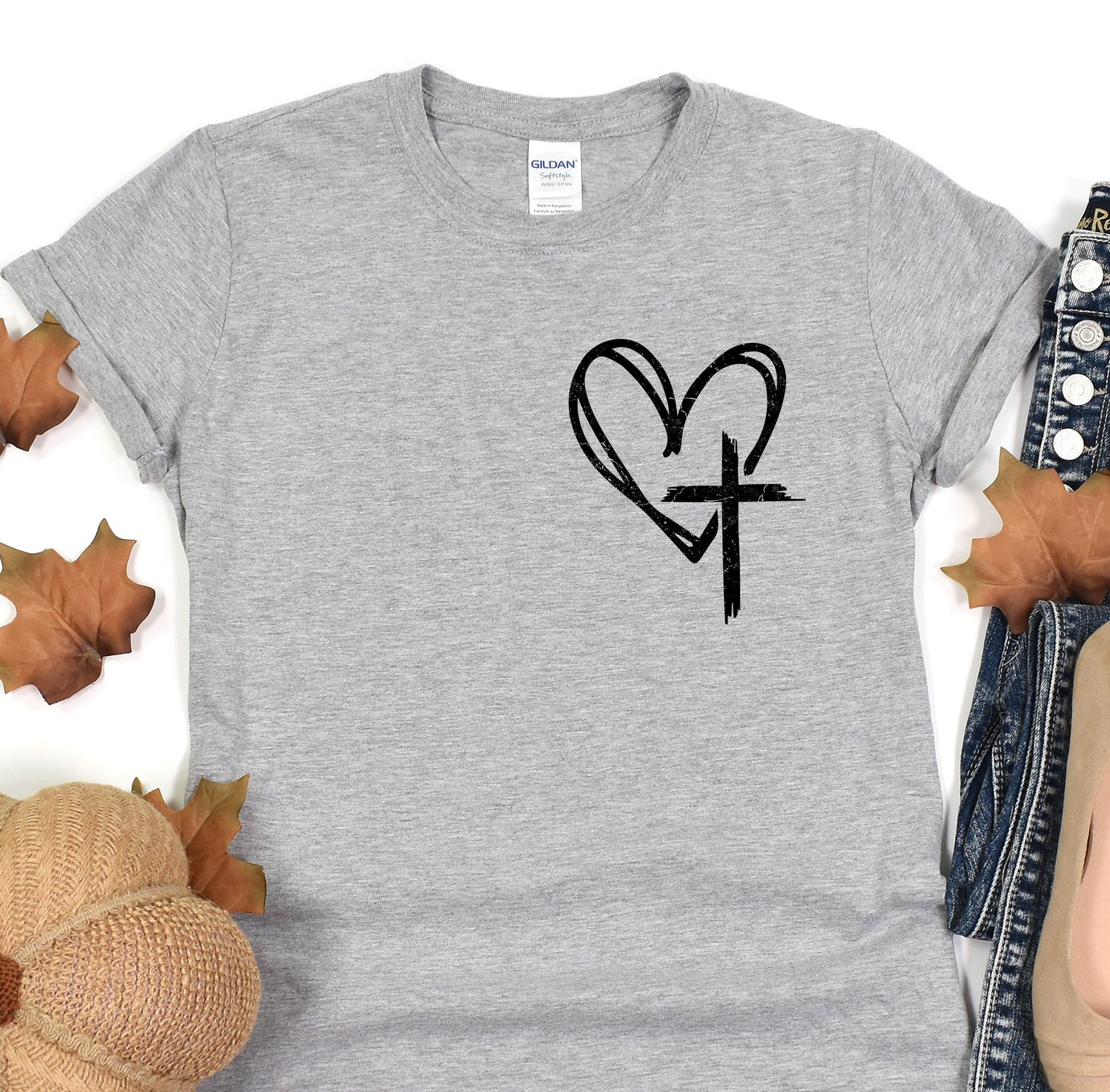 a t - shirt with a heart and a cross on it