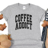 a t - shirt that says coffee addict on it