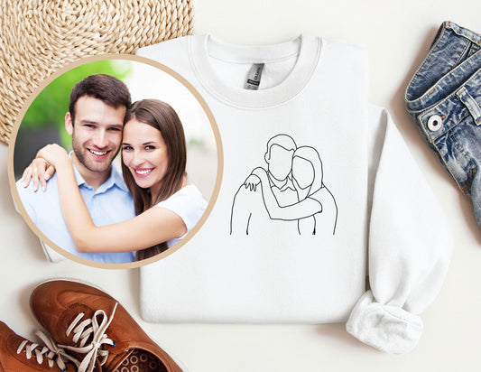 a picture of a man and woman on a sweater next to a pair of shoes