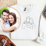 a picture of a man and woman on a sweater next to a pair of shoes