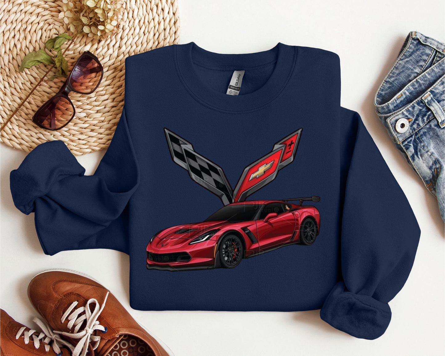 a blue sweatshirt with a red sports car on it