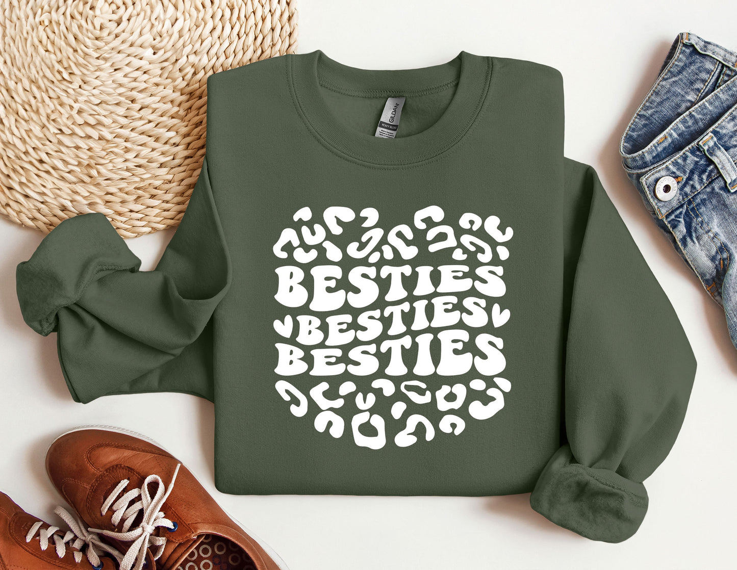 a green sweatshirt with the words besties written on it