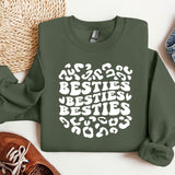 a green sweatshirt with the words besties written on it