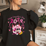 a woman is sitting on a bed wearing a black shirt