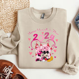 a pair of sneakers and a sweater with a cartoon character on it