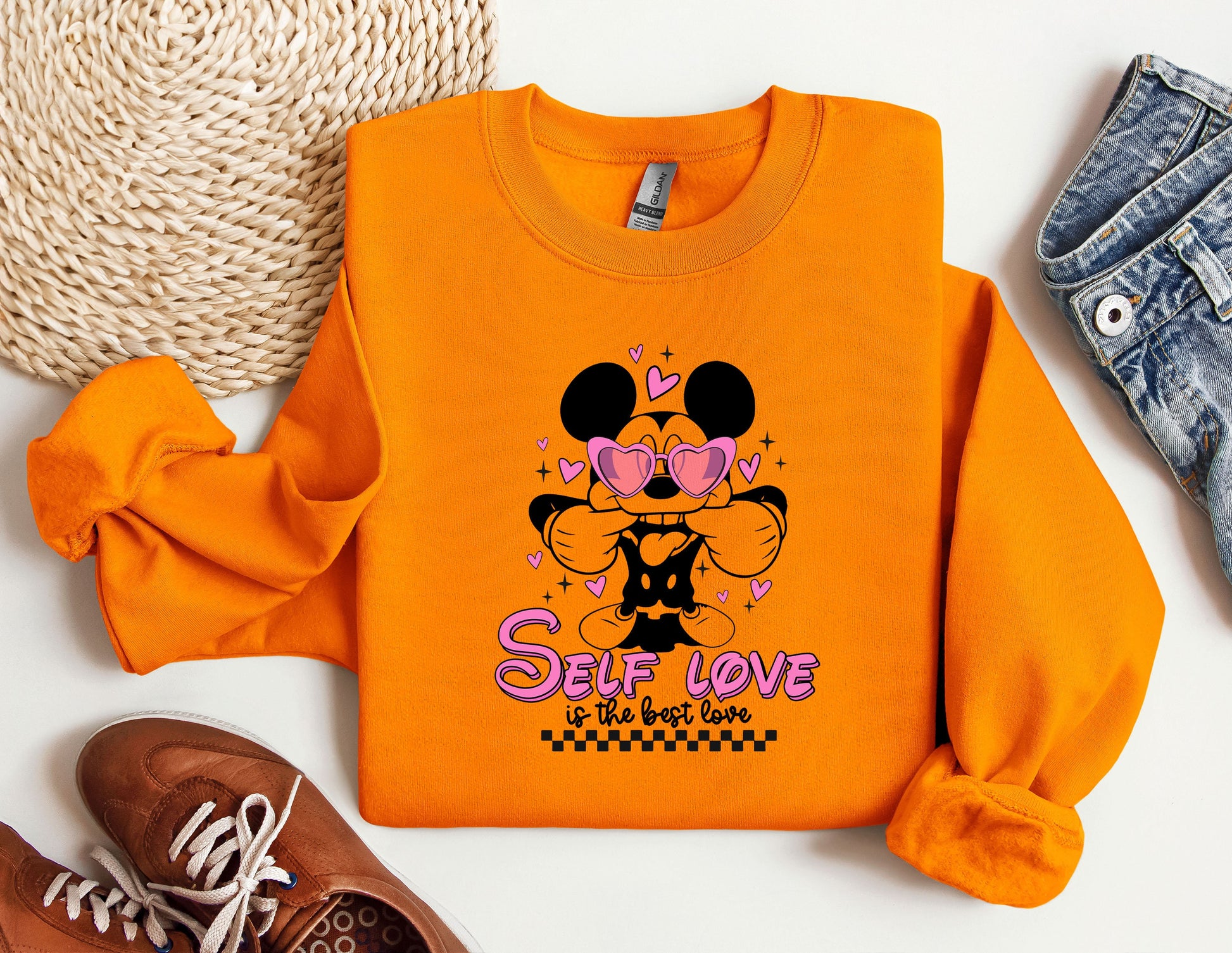 an orange shirt with a mickey mouse design on it