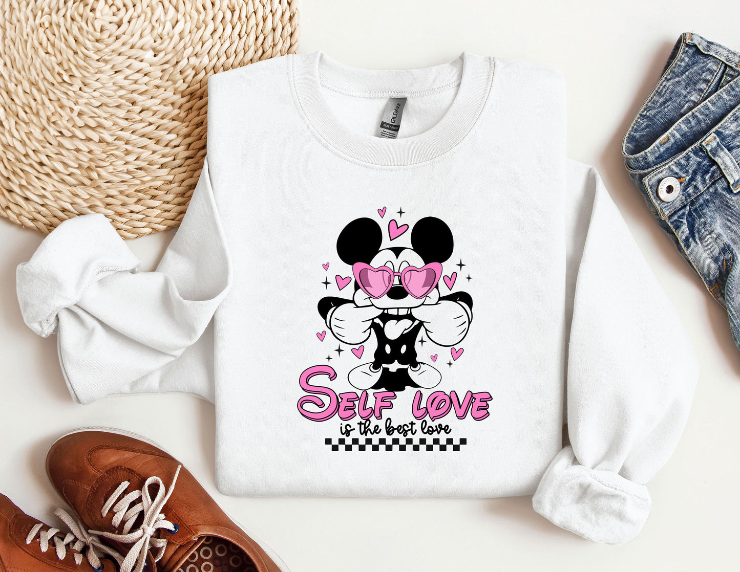 a minnie mouse sweatshirt with a pair of shoes next to it