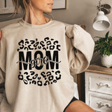 a woman wearing a sweatshirt with the word mom printed on it