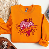 a pair of shoes and an orange shirt on a white surface